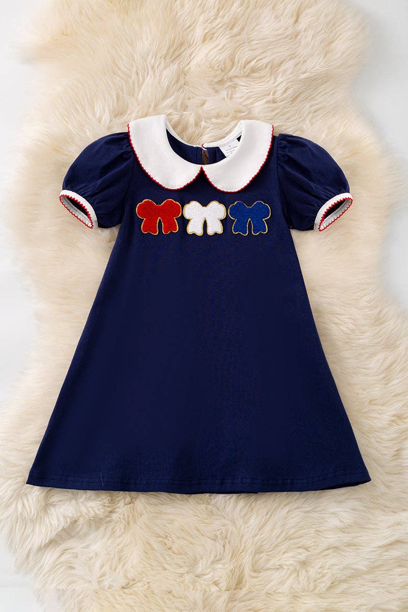 Bow applique on navy blue dress. DRG60697 Jean