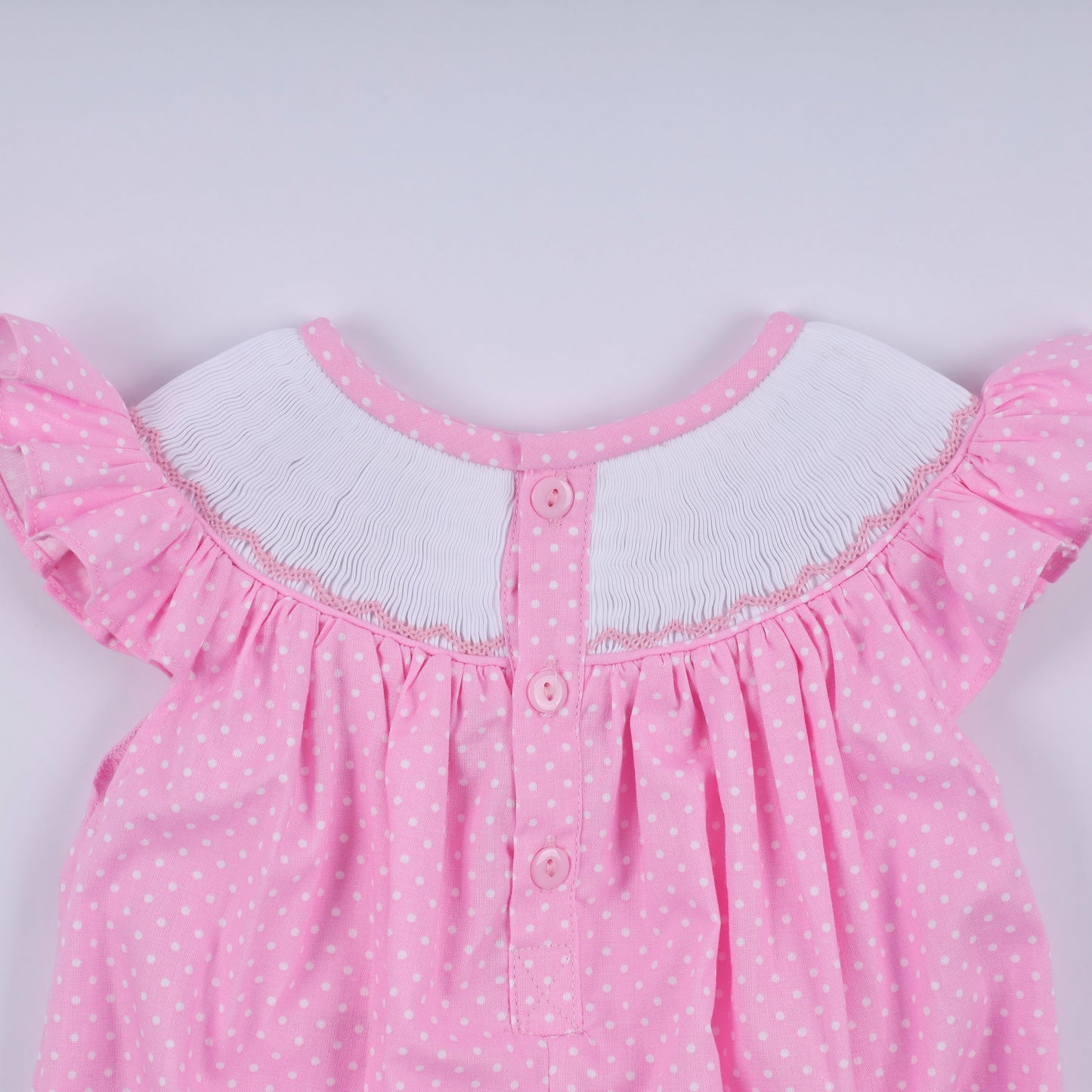Pink character hand smocked dot ruffle bubble